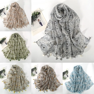 Detailed views of paisley printed scarves with handmade tassels in multiple colors