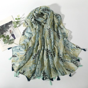 Linen feel printed scarf with leaf patterns and tassels in light green and yellow