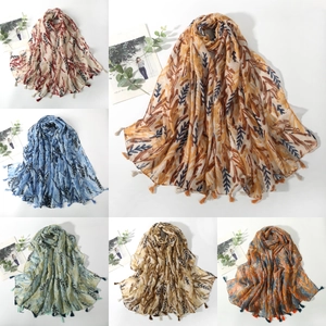 Six leaf-patterned scarves with fringed edges in various vintage colors on white background