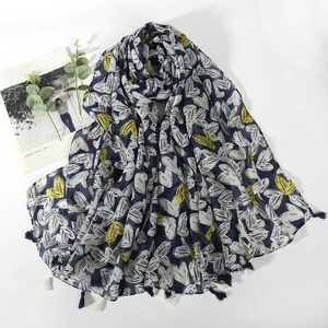 Macro shot of navy scarf with heart prints and decorative fringed tassels
