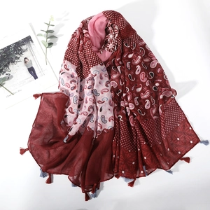 Vintage paisley print scarf with red tassels and patchwork design on white background