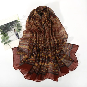 Lightweight bali voile scarf with geometric tribal patterns in deep red and yellow