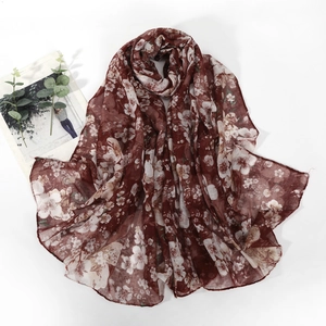 Detailed texture of burgundy floral scarf made of lightweight and breathable cotton fabric