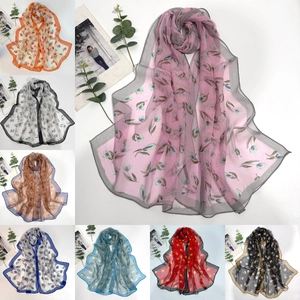 Close-up of semi-transparent georgette scarf with elegant tulip and daisy prints