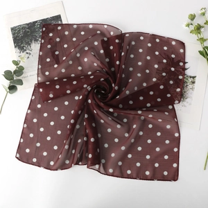 Détail du foulard carré en mousseline bordeaux à pois blancs sur fond blanc épuré