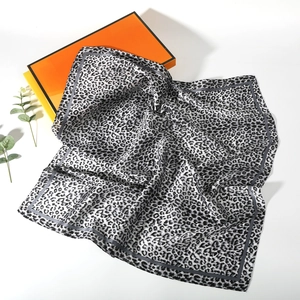 Detail shot of leopard print silk scarf in black and white with premium gift box