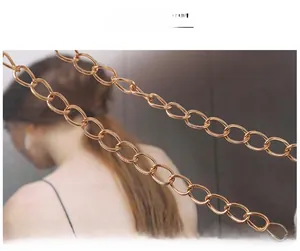 Close-up of elegant gold chain shoulder strap with durable metallic links for handbags