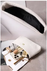 Detail of white woven handbag showing large capacity for phone, perfume and daily items
