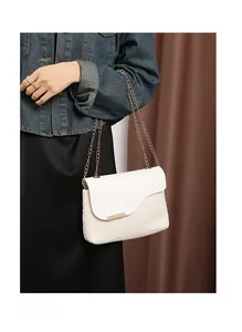 Detail of cream woven shoulder bag with faux leather flap and elegant gold chain strap