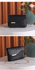 Close-up of black woven shoulder bag with gold chain and contrasting textures