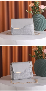 Close-up of woven chain handbag with grey leather flap and gold metal hardware detail