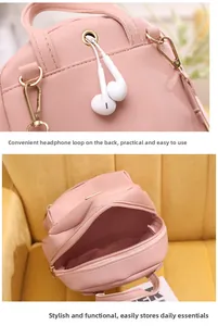 Pink pebbled leather mini backpack detail with headphone jack and golden hardware