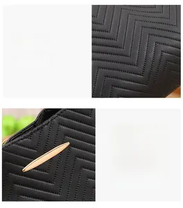 Detail of V-shaped quilted leather texture and premium gold metal hardware on handbag