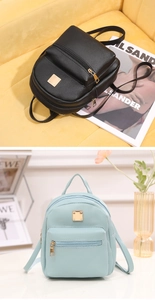 Detail of mini lychee leather backpacks in black and light blue with gold metal accents