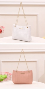 Detail of V-quilted faux leather shoulder bags in white and pink with gold chain straps