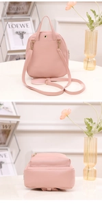 Detail of pink mini backpack featuring adjustable straps and gold metal hardware hooks