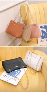 Close-up of elegant V-quilted handbags with gold chain straps in five vibrant colors