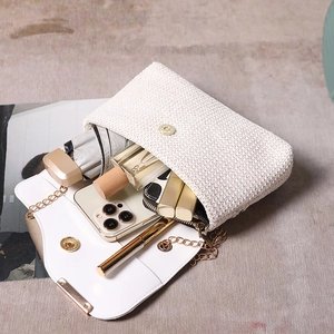 Chic woven beige chain handbag with internal storage showing daily essentials