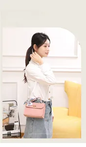 Elegant pink crossbody bag with golden twist lock and decorative silk scarf handle
