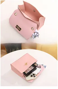 Pink woven texture shoulder bag interior showing daily items and scarf detail