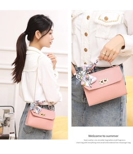 Detail of pink quilted chain bag with gold hardware and decorative floral scarf handle
