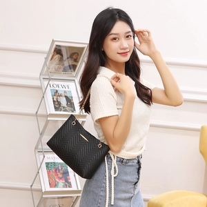 Elegant black chevron quilted shoulder bag with gold chain strap and metal trim