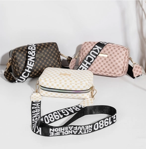 Detailed view of women's printed square crossbody bags with stylish wide woven straps
