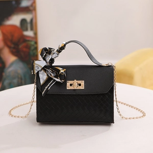 Elegant black leather handbag with woven texture and decorative silk scarf handles