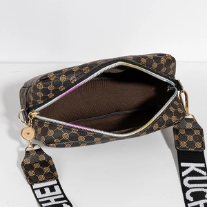 Brown monogram camera bag with wide contrast strap and gold hardware on white background