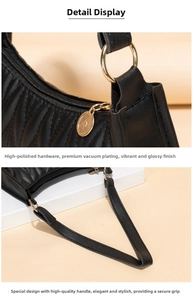 Detail of black quilted shoulder bag featuring gold ring hardware and logo zipper