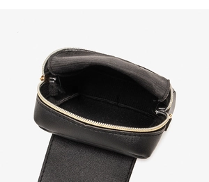 Detail view of the black PU leather crossbody bag with fabric lining and gold zipper