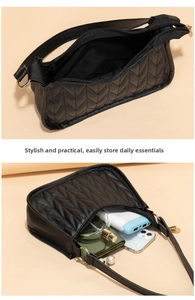 Interior view of black V-quilted baguette bag showing high capacity storage for essentials