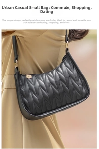 Close-up of black V-quilted underarm bag with gold hardware worn on shoulder