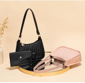 Close-up of chevron quilted underarm bags and envelope wallet with gold logo charm