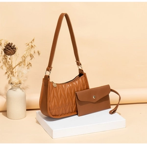 Detail of brown quilted underarm bag set with matching small coin purse and metal zipper