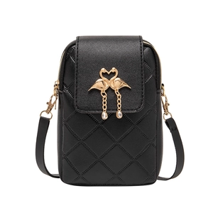 Quilted black crossbody phone bag featuring a gold flamingo charm on a white background