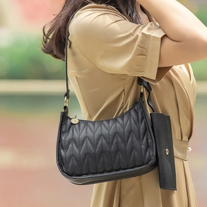 Black quilted hobo bag with V-shaped stitching and small matching coin purse