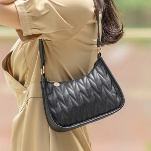 Quilted black PU leather underarm bag with V-shaped texture and gold hardware details