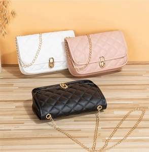 Detailed trio of quilted chain bags in white pink and black with gold hardware and locks