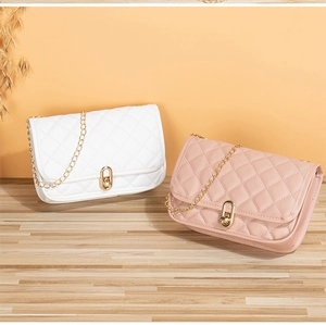 Detailed view of quilted faux leather texture with elegant gold twist-lock closure