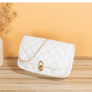 Close-up of white quilted crossbody bag with gold chain strap and twist lock