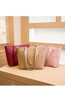 Close-up of quilted tote bags in burgundy, khaki, and pink on a retail display stand