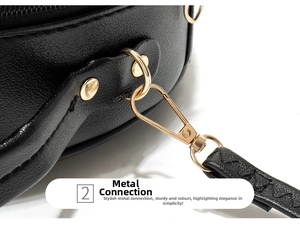 Detailed macro view of the gold-tone metal hardware and lychee grain leather on black bag