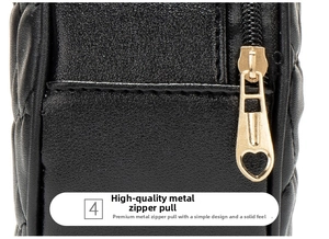 Detail shot of golden heart zipper pull on quilted black leather crossbody phone bag