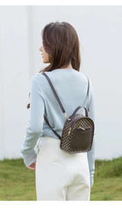 Outdoor shot of a mini printed backpack for women with vintage brown floral pattern