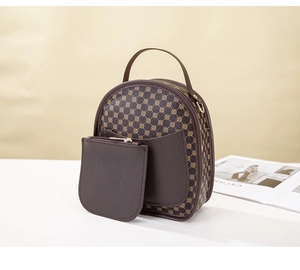 Detail view of vintage printed handbag with matching mini wallet and golden zipper accents