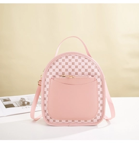 Detailed close-up of pink mini backpack with luxury monogram print and top handle