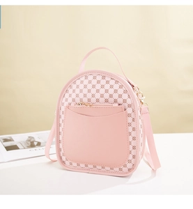 Detail of light pink mini backpack featuring retro floral print and golden zippers