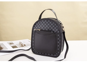 Close-up of mini black PU leather backpack featuring gray geometric print and gold zipper