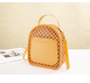 Detail of a bright yellow patterned mini crossbody bag with a front zipper pocket